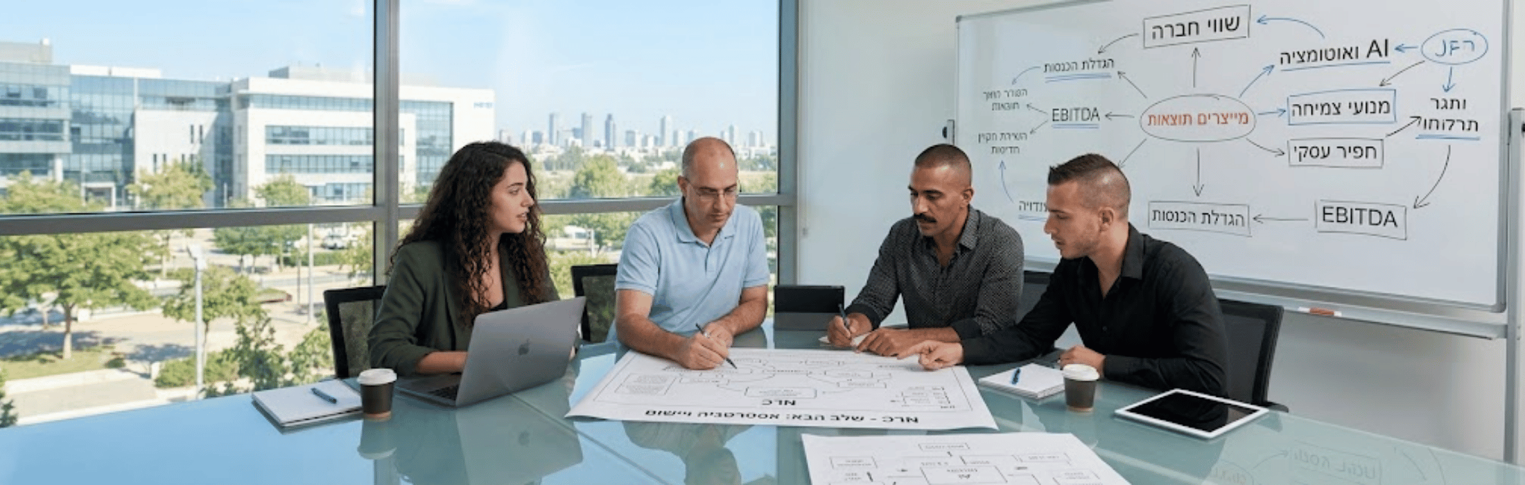 Four professionals sit around a glass table reviewing large printouts; a laptop and tablet are open as a whiteboard with Hebrew diagrams looms in the background.